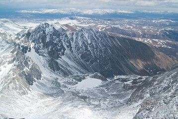 View from the top of the frozen lake and the snowy peaks of the mountains