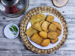 top view of Gorengan, Fried food with chili and a glass of water