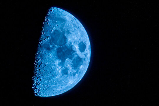 half moon in the night sky in december