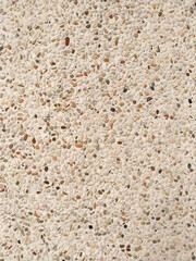 Tiny pebbles on white wall, close lightly pebble background surface
