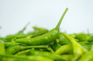 Green Thai chile peppers vary in size and shape, depending on the specific variety, and are generally small, conical, and slender, tapering to a point on the non-stem end.