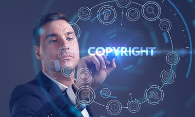 Business, Technology, Internet and network concept. Young businessman working on a virtual screen of the future and sees the inscription: Copyright