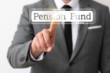 Businessman with text PENSION FUND on light background