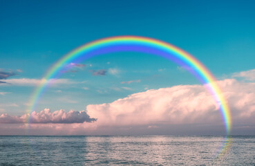 Beautiful view of sea with clouds and rainbow in sky on summer day