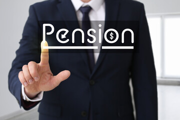 Obraz premium Young businessman with word PENSION indoors