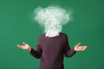 Young man with atomic bomb explosion instead of head on color background