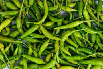 Green Thai chile peppers vary in size and shape, depending on the specific variety, and are generally small, conical, and slender, tapering to a point on the non-stem end.