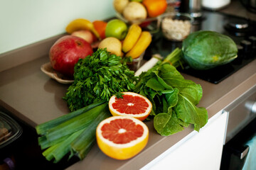 There are fresh vegetables and fruits on the table.