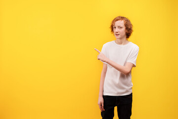 Empty space for text. Yellow background. A teenage boy holds his index finger up.