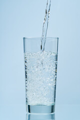 Pouring water. Pouring fresh clean drinking water to glass.