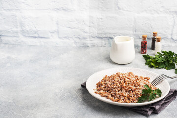 Boiled buckwheat on a plate. Healthy porridge enriched with vitamins. copy space,