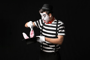 Male pantomimist on dark background