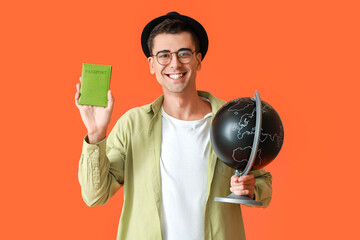 Male tourist with globe and passport on color background