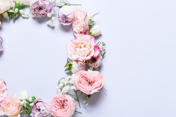 Frame made of beautiful flowers on light background