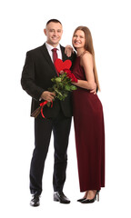 Young couple with flowers and red heart on white background. Valentine's Day celebration