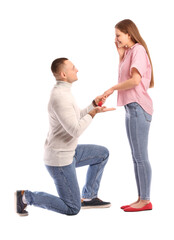 Young man proposing Valentine's Day on white background