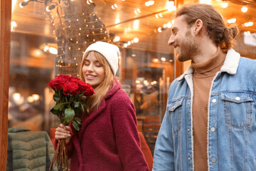 Happy young couple walking in city on Valentine's Day