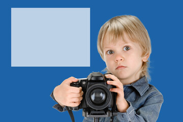 Portrait of creative little boy with digital camera posing on background with copyspace