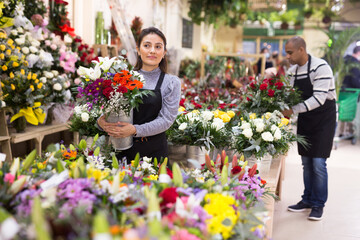 Fototapeta premium Flower seller prepares a luxury bouquet at a flower shop