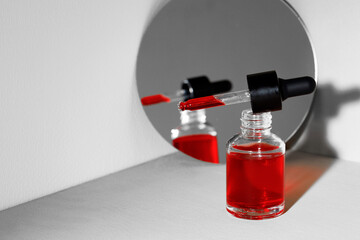 Creative photo with glass jar ofcosmetic oil and mirror