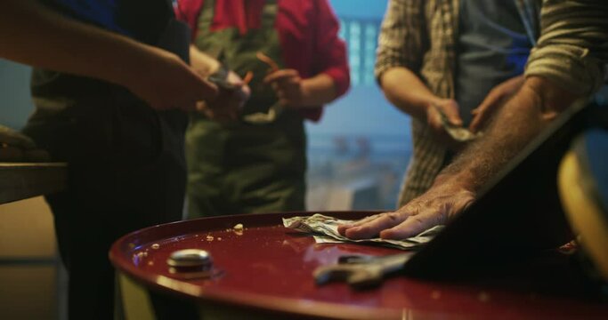 Crop men betting money while watching match