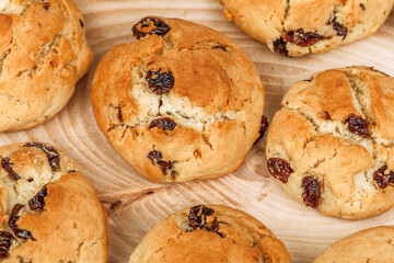 Plenty of raisin cookies on wooden plate