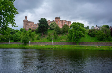 Fototapeta na wymiar Inverness Castle is a red sandstone construction as seen from across River Ness.