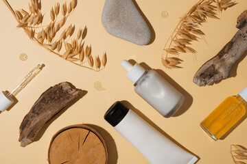 Natural cosmetic concept with serum and cream tube and bottles with natural materials