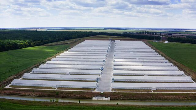 Agricultural new modern buildings in rural area. Poultry farm built in field. Industrial place for cattle growing. View from above.