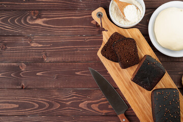 Sliced rye bread on brown wooden background