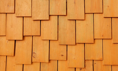 The wall of wooden boards is yellow-orange. The theme of the structure and texture. Layering. Interior design. Eco-friendly materials in construction. Ecology concept.