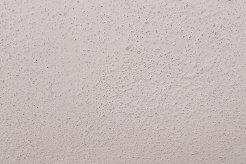 Closeup of white wall with black dots background