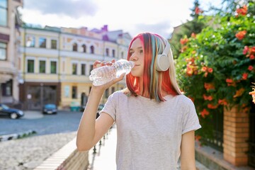 Summer, heat in city, young woman with bottle of water