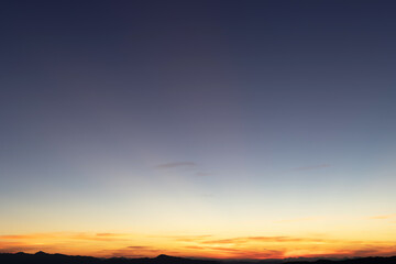 Heaven at early morning with copy space. Sunset, sunrise backdrop.Predawn clear sky with orange horizon and blue atmosphere. Smooth orange blue gradient of dawn sky.