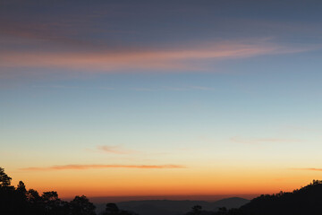 Heaven at early morning with copy space. Sunset, sunrise backdrop.Predawn clear sky with orange horizon and blue atmosphere. Smooth orange blue gradient of dawn sky.