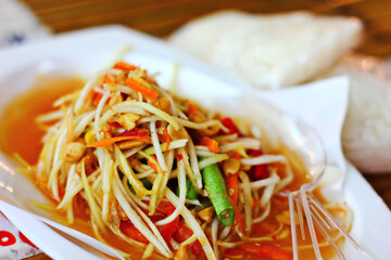 close up Thai street food somtum papaya mix bean vegetable fish sauce chili and dried shrimp