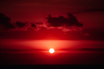 Sunrise / sunset over the ocean and horizon in golden colors.
