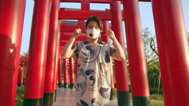 young attractive asian female wearing face mask virus protective at japan tradition temple safety travel new normal lifestyle