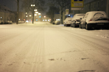 Blurry shot of cars parked along the street side covered with snow in winter