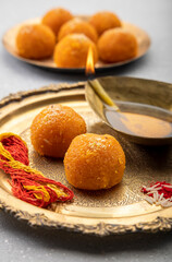aarti and puja metal plate with ladoo prashad in traditional hindu puja