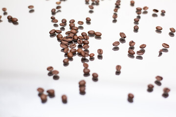 Falling coffee beans. White background.