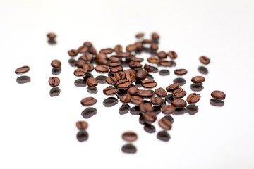 Falling coffee beans. White background.