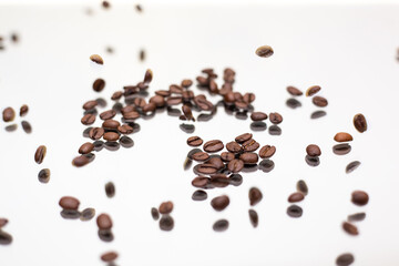Falling coffee beans. White background.