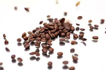 Falling coffee beans. White background.