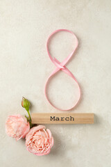 8 made of ribbon, wood block with text March and roses on white textured background