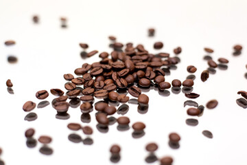 Falling coffee beans. White background.