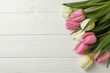 Bouquet of tulips on white wooden background, space for text