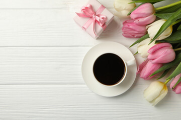Tulips, coffee and gift box on white wooden background, space for text