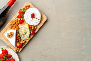 Composition of cheese, and fruits on gray table