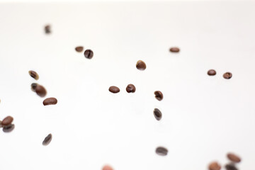 Falling coffee beans. White background.